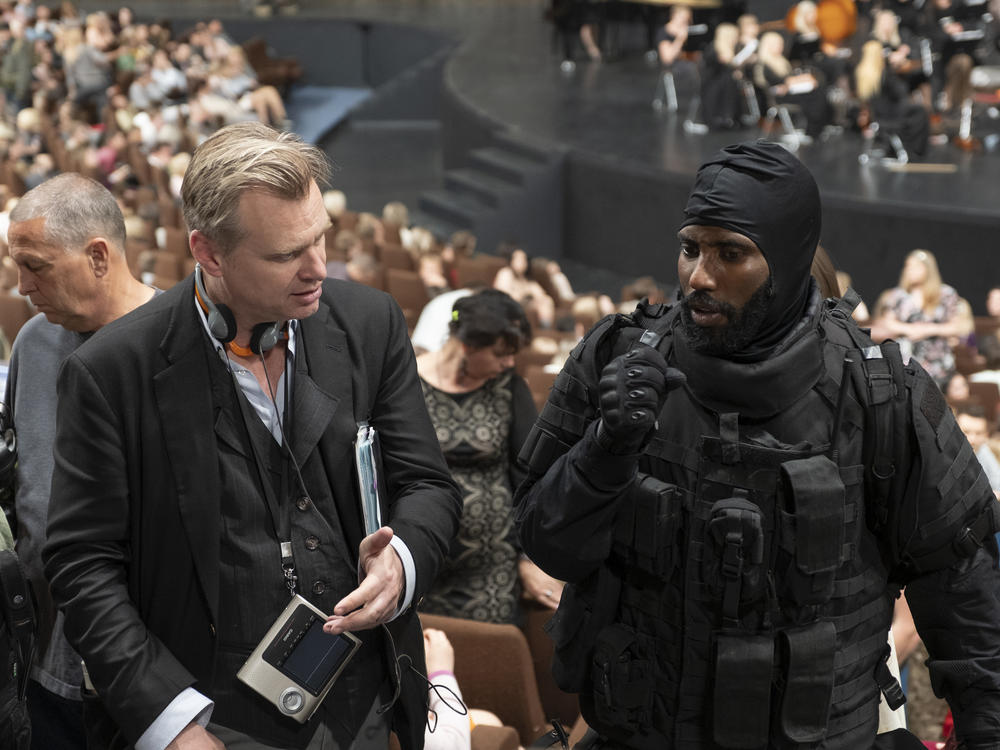 Director Christopher Nolan (left) and actor John David Washington on the set of <em>Tenet</em>.