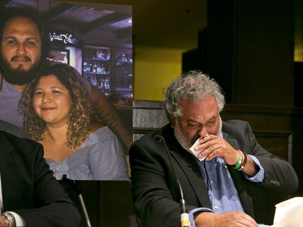 Albert Corado (right), the father of Melyda Corado, seen in a portrait with her brother Albert Corado Jr. His daughter, assistant manager of a Trader Joe's in Los Angeles, was killed by a police bullet when an armed suspect fled into the store in July 2018.