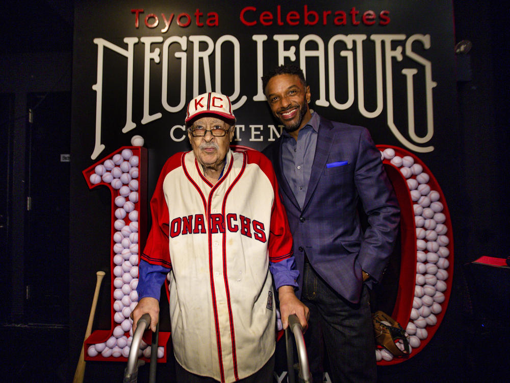 Negro Leagues baseball veteran Jim Robinson and ESPN/ABC correspondent Ryan Smith attend an event celebrating 100th anniversary of the league in New York in February.