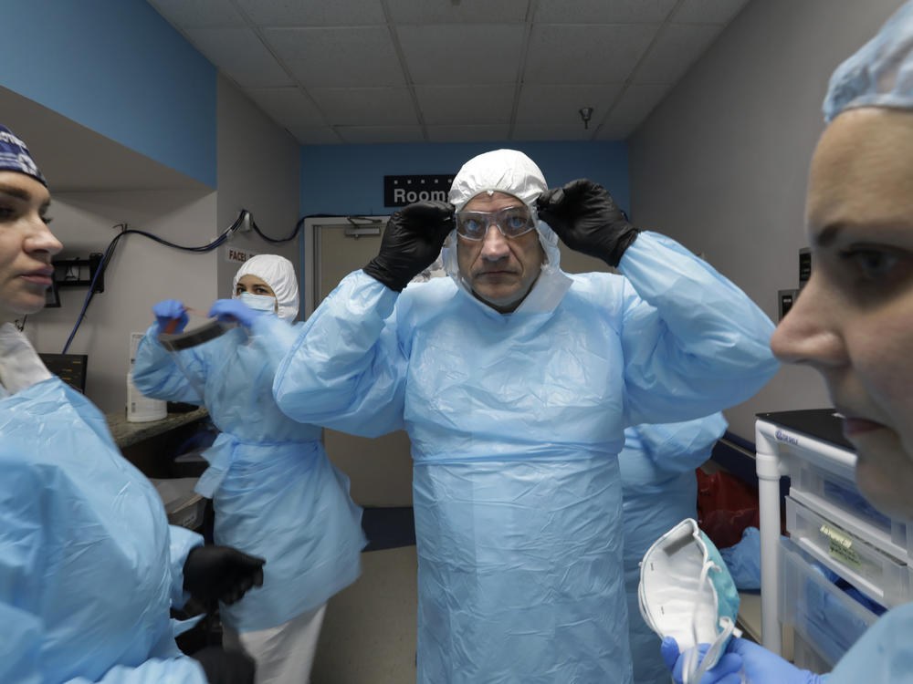 Dr. Joseph Varon prepares to enter the COVID-19 unit at Houston's United Memorial Medical Center in May. With him are nurses Tanna Ingraham (left) and Jerusha Harshman (right).