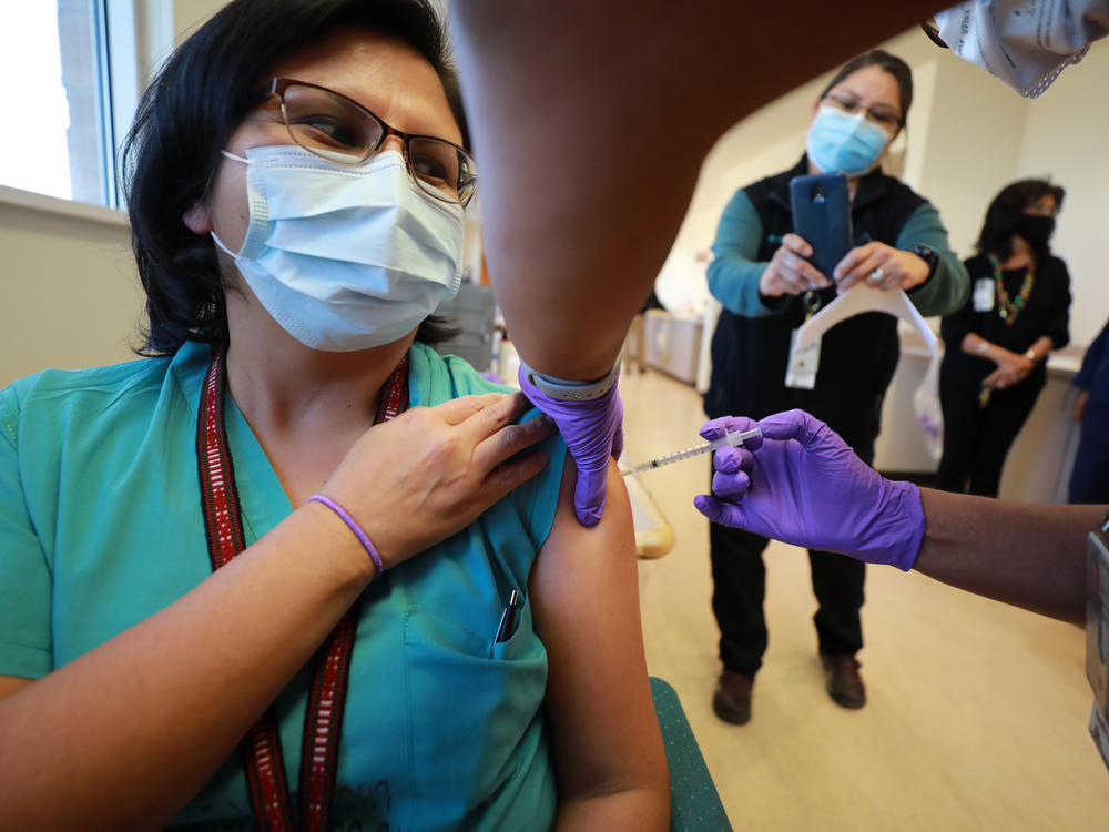 Dr. Lawanda Jim, Chair of Internal Medicine, receives a COVID-19 vaccine at Northern Navajo Medical Center on Tuesday in Shiprock, N.M.