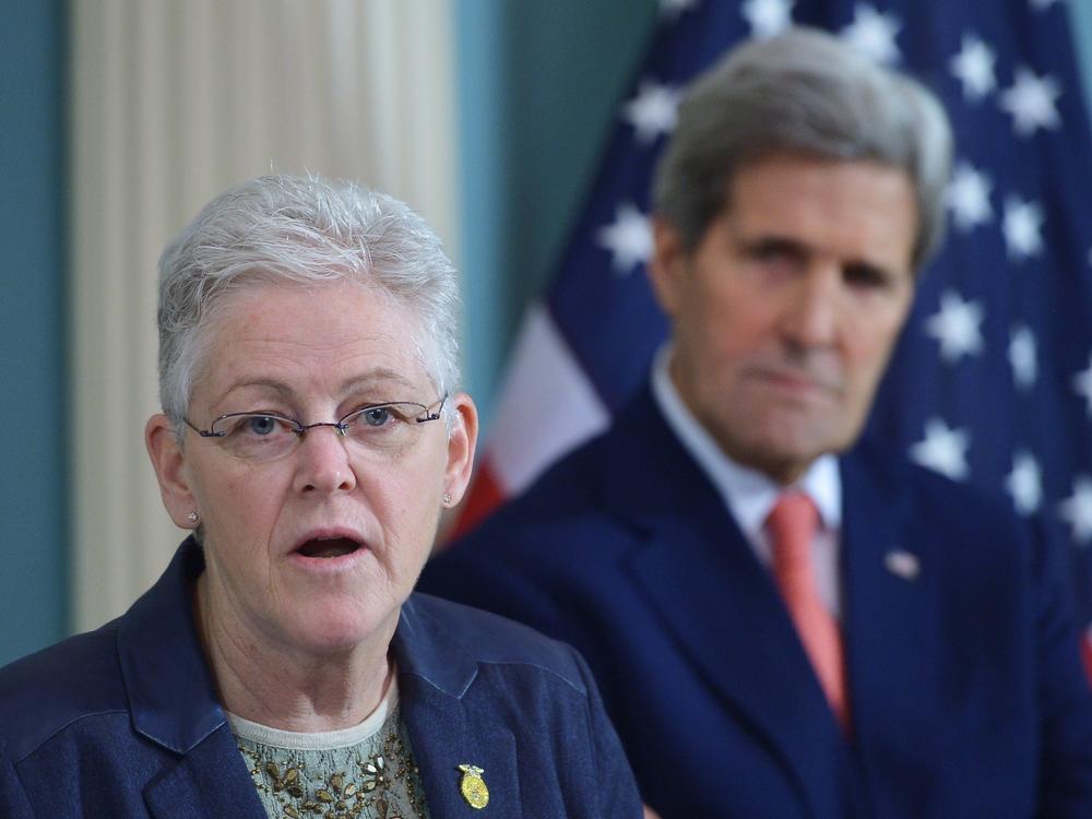 Then-Environmental Protection Agency Administrator Gina McCarthy speaks during a 2015 signing ceremony for an air quality agreement as then-Secretary of State John Kerry looks on. The two will be back together working on climate issues in the Biden administration.