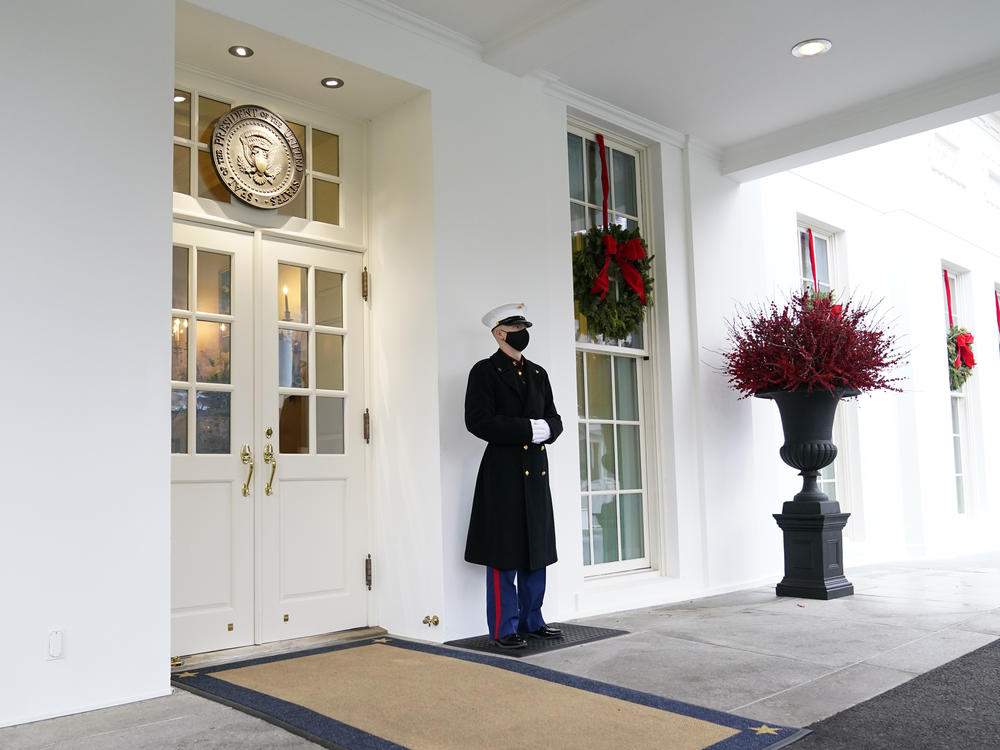 A Marine stands outside the West Wing of the White House last week. President Trump has been lobbied by advocates to use his powers to grant pardons and commutations ahead of leaving office.