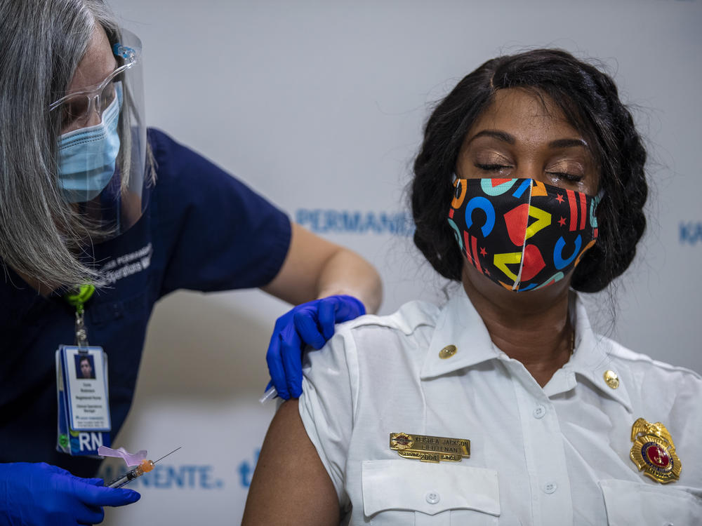 Washington, D.C., Fire and EMS Lt. Keishea Jackson gets a Pfizer coronavirus vaccine shot on Thursday.