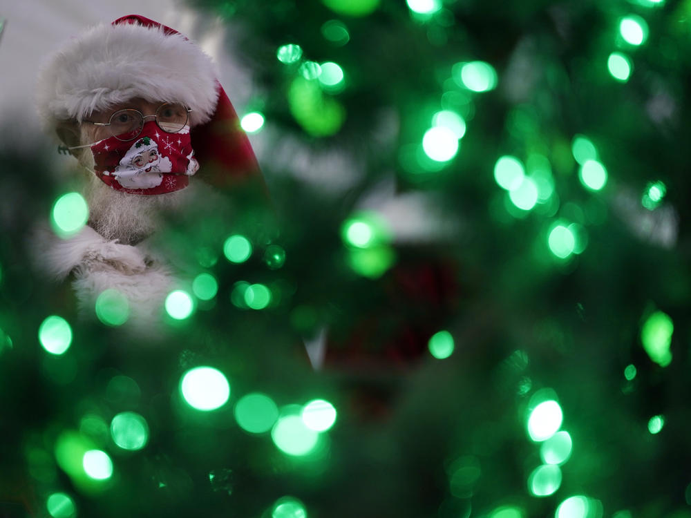 Bill Sandeen, dressed as Santa Claus, waits for the opening of a Santa drive-through selfie station in Las Vegas on Dec. 10. The real Santa was vaccinated by Dr. Anthony Fauci at the North Pole.