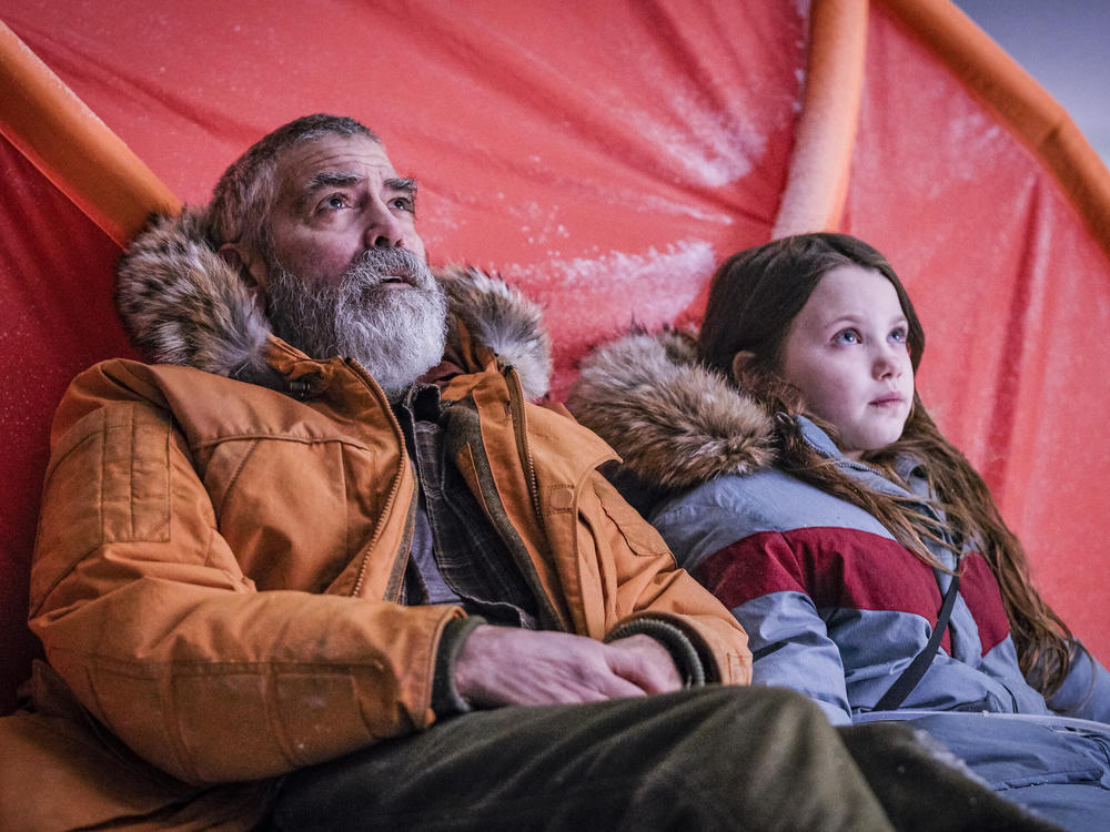 George Clooney and Caoilinn Springall, right, in a scene from the sci-fi film Clooney directed, <em>The Midnight Sky.</em>