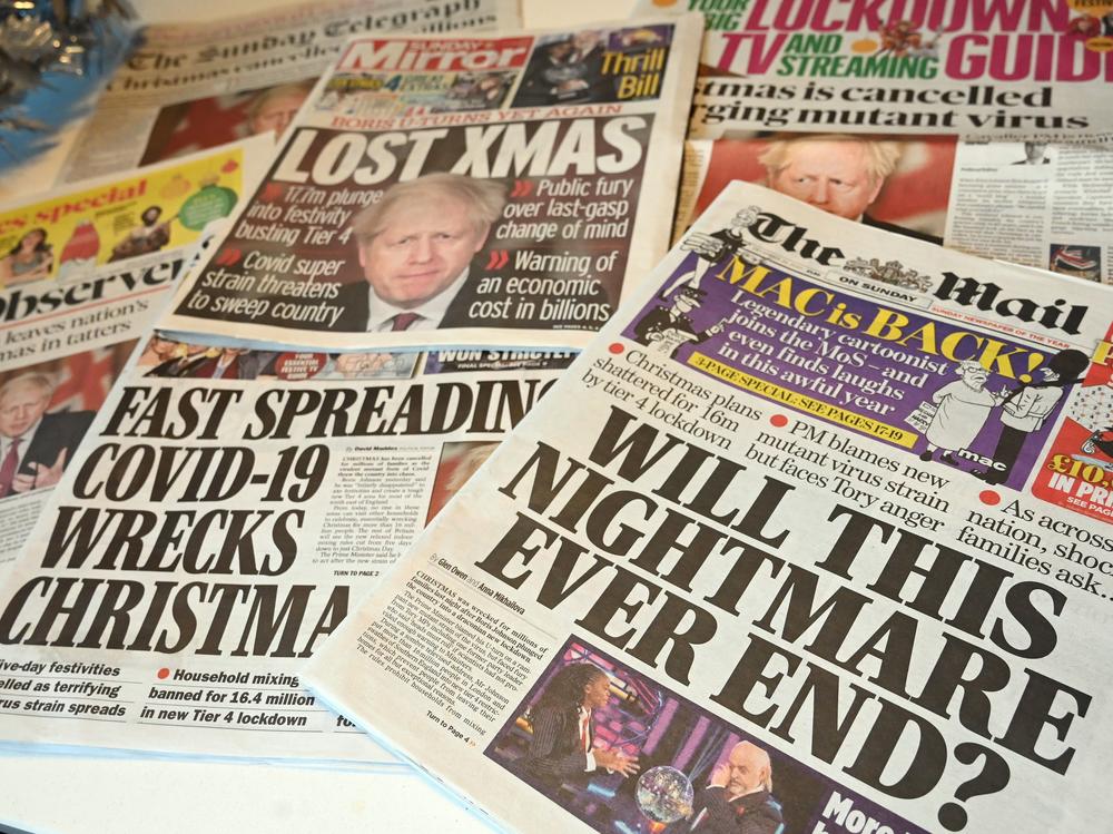 An arrangement of U.K. daily newspapers shows front page headlines reporting on the tight new coronavirus restrictions for London and the southeast of England, cancelling Christmas gatherings for those in the new 