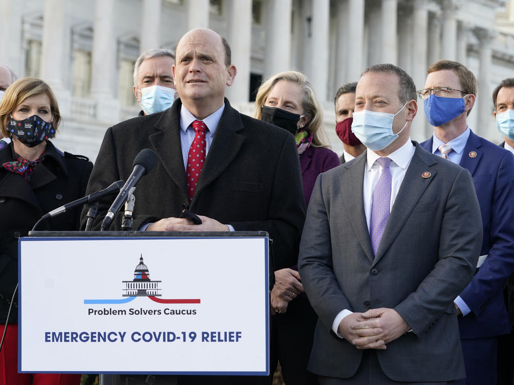Members of the bipartisan Problem Solvers Caucus — co-chairs Rep. Tom Reed, R-N.Y., at lectern, and Rep. Josh Gottheimer, D-N.J., to his right — took credit for helping to break the logjam on an emergency COVID-19 relief bill.