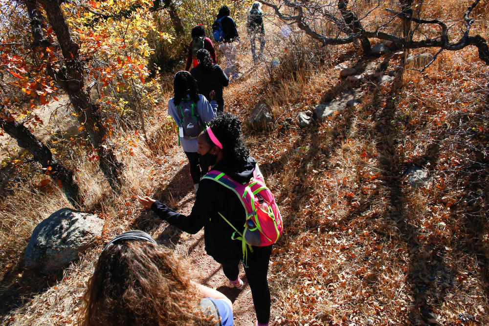 Members of Vibe Tribe Adventures, an organization founded in Colorado to encourage Black women to participate in outdoor excursions, hike through Bear Creek Regional Park on Oct. 24 in Colorado Springs.