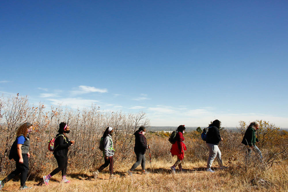 (Left to right) Theresa Odello, Jessica Newton, Jan Garduno, Ashanta Cyprian, Joy Eloi and Jewyl Newton follow Lynn Wilson on a hike in a Colorado Springs park. Studies show 