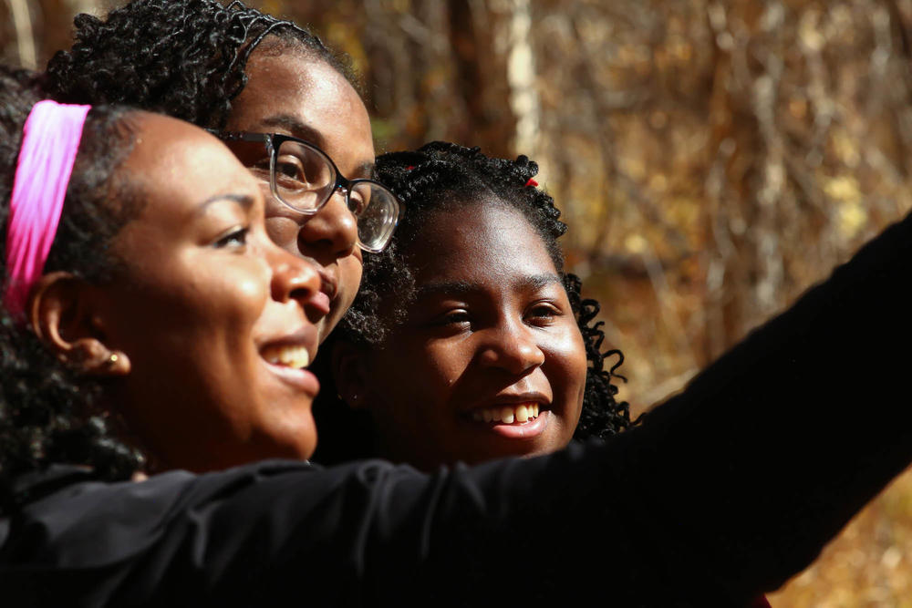 (Left to right) Jessica Newton, her 16-year-old cousin Jewyl Newton, and her 14-year-old daughter Joy Eloi pause to take a selfie mid-hike.