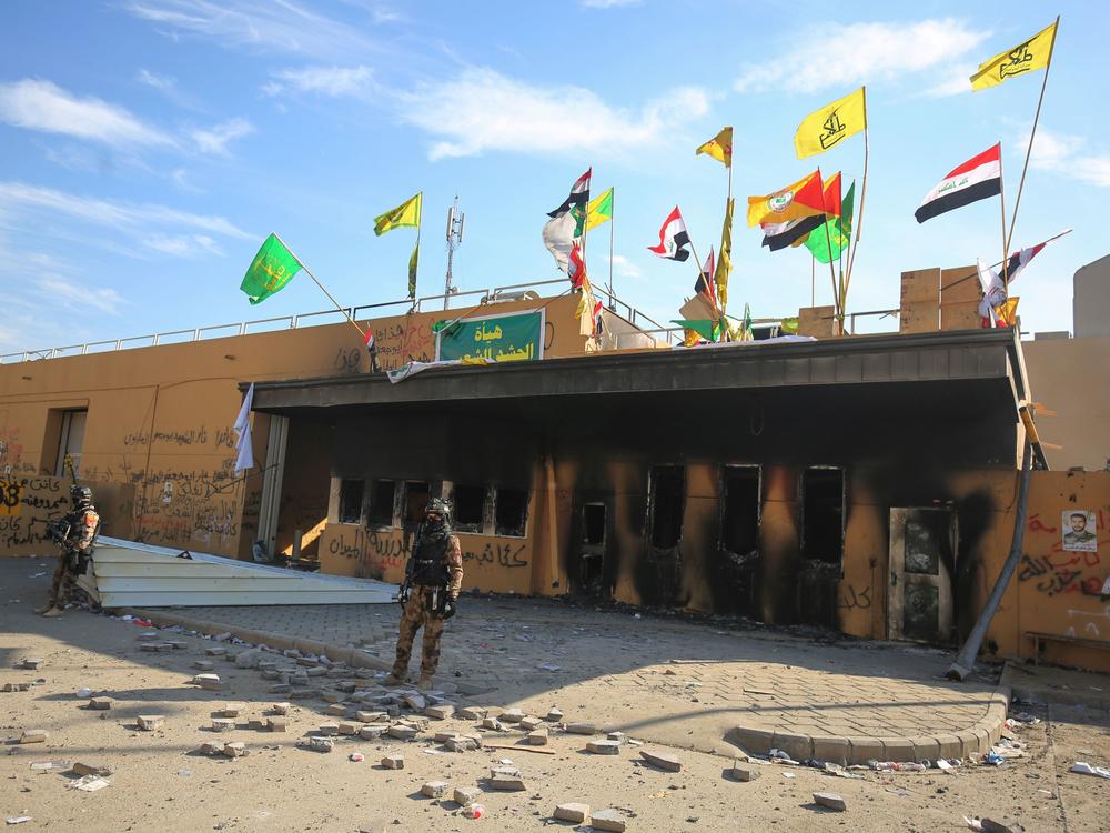 Iraqi security forces stand guard in front the U.S. embassy in Baghdad on Jan. 1. Over the weekend, eight small rockets launched by Iranian forces specifically targeted the International Zone in Baghdad, also called the 