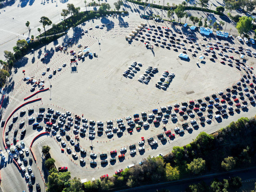 Cars are lined up at Dodger Stadium in Los Angeles for coronavirus testing. Nearly 2 million people are getting tested a day in the U.S. A new analysis shows millions more are needed to protect the most vulnerable.