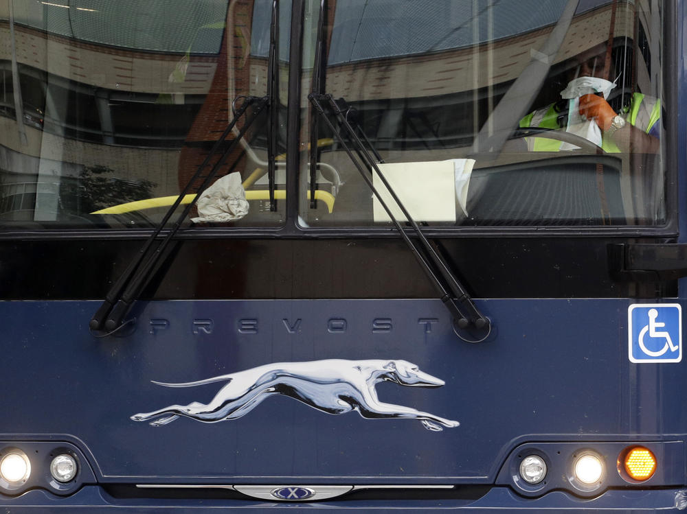 A Greyhound bus driver wears a protective mask and gloves as he prepares to depart a station in San Antonio, Texas, on March 30. Bus companies are struggling amid the pandemic, cutting off travel options for lower-income Americans.