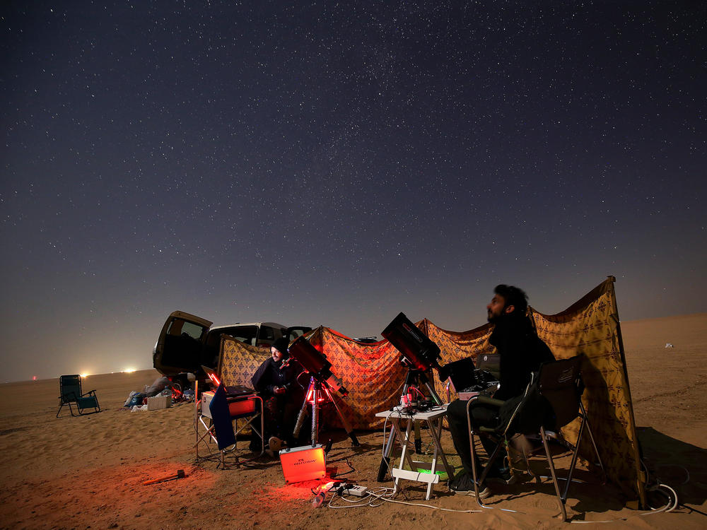 Kuwaiti photographers follow the alignment in al-Salmi district, a desert area about 75 miles west of Kuwait City.