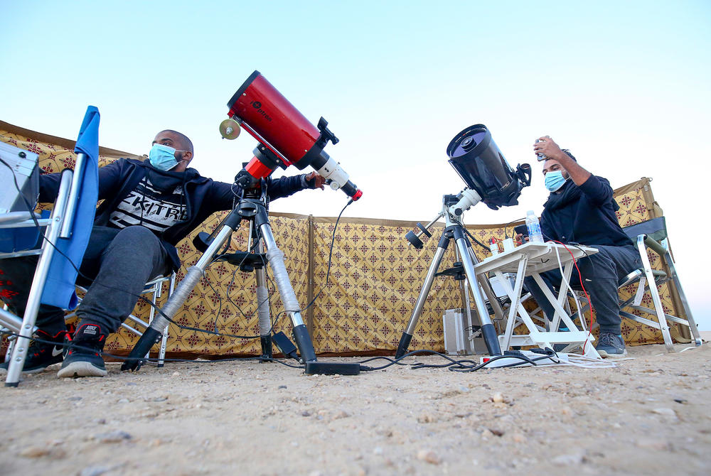 Kuwaiti astrophotographers Mohammad al-Obaidi, right, and Abdullah al-Harbi follow the Great Conjunction in al-Salmi district, a desert area west of Kuwait City.