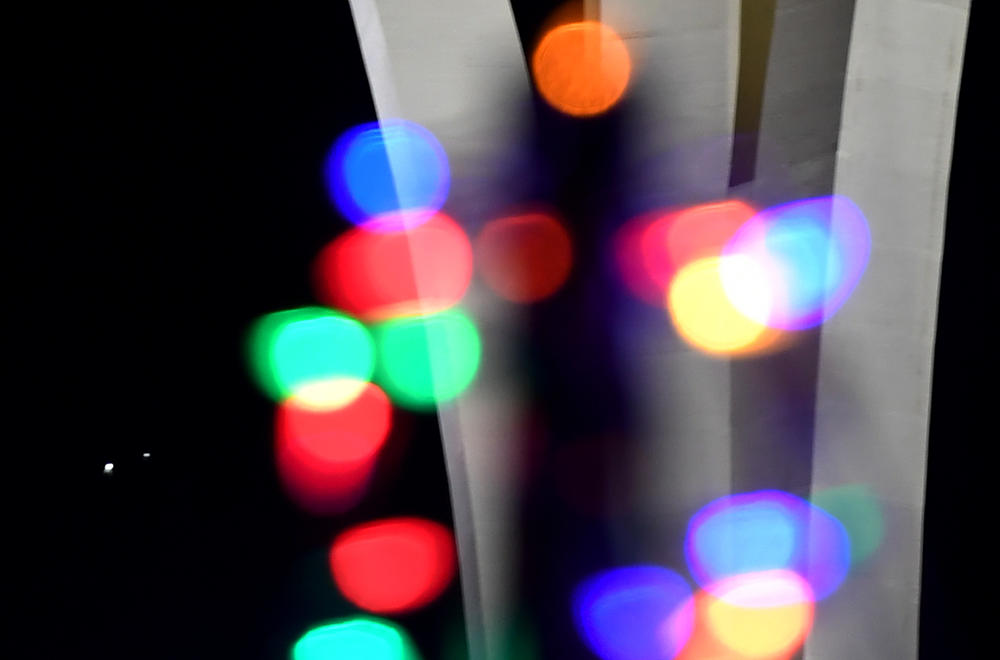 Jupiter, left, and Saturn appear about one-tenth of a degree apart. Here they are seen behind Christmas lights in Las Vegas.