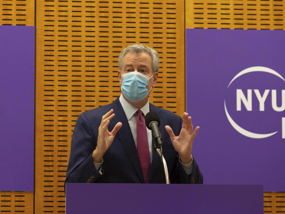 New York City Mayor Bill de Blasio announced that sheriff's deputies will be deployed to enforce quarantine protocols for travelers arriving from the United Kingdom. The mayor is seen above on Dec. 14. while delivering remarks ahead of the first COVID-19 vaccinations at NYU Langone Hospital.