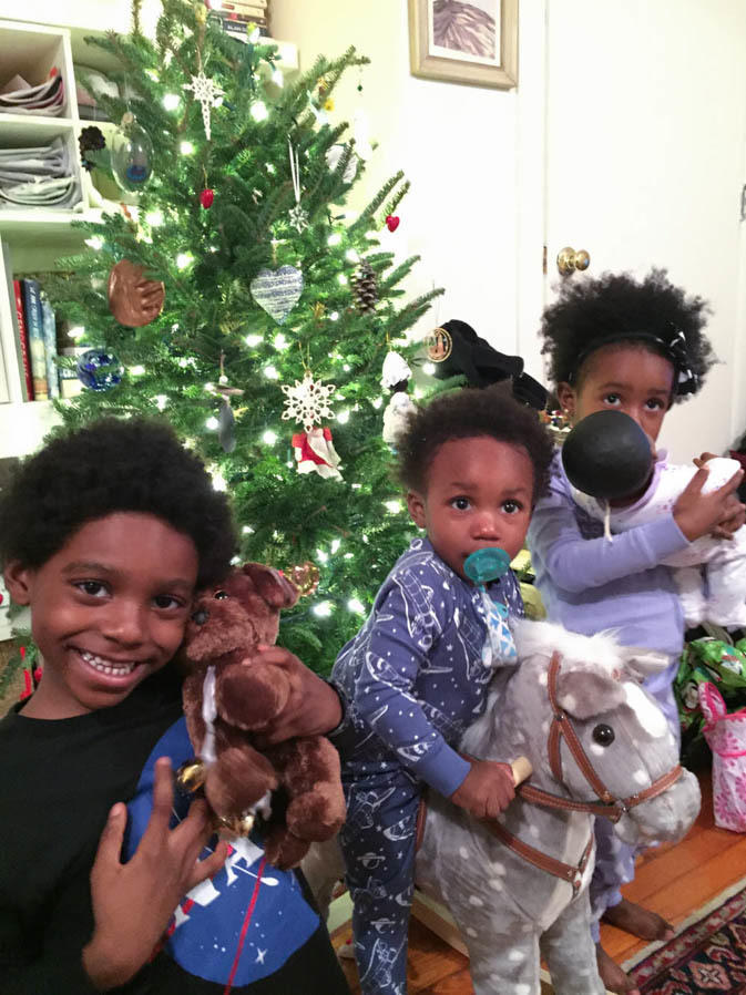 Yennie Neal-Achigbu's kids, Zuri (from left), Xoan and Lyon, celebrate the first of many Christmases with Jamie Olivieri in 2014, months after the death of Neal-Achigbu's husband.