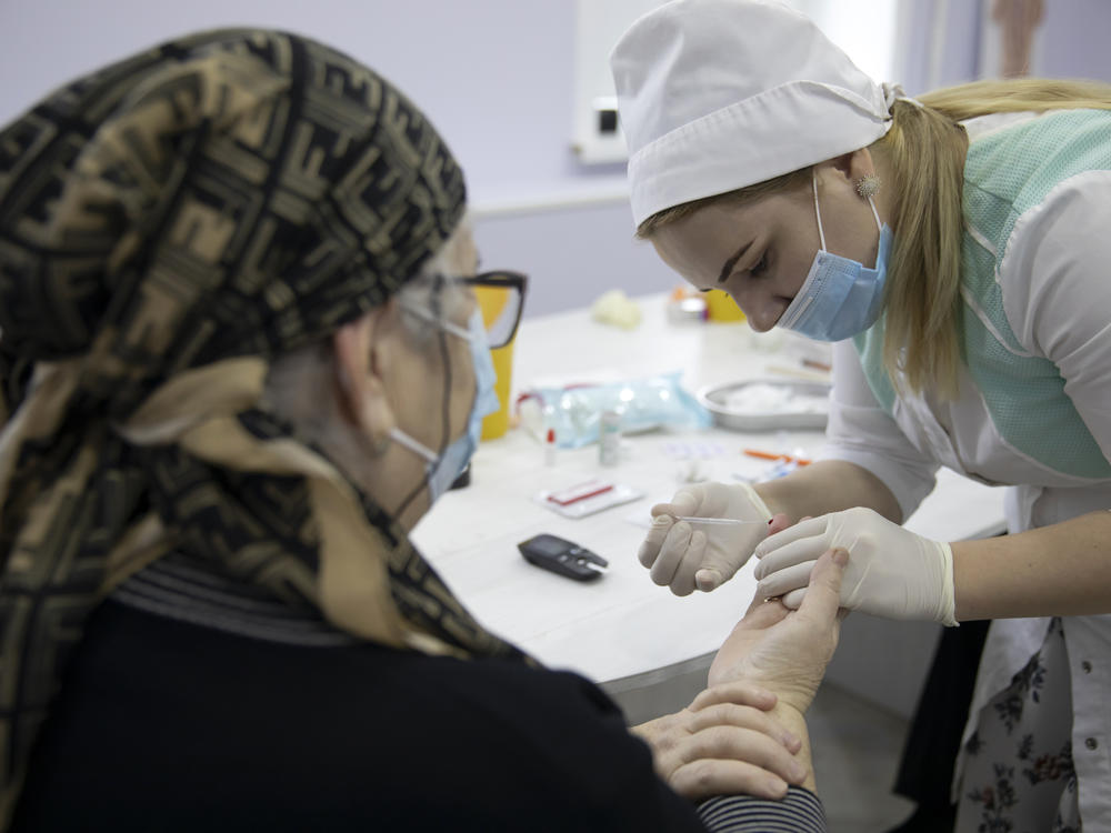 A woman undergoes antibody testing before an injection of the Russian COVID-19 vaccine known as Sputnik V at an outpatient clinic in Grozny earlier this week.