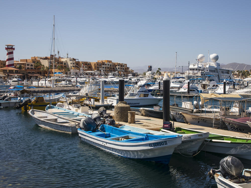 Many Americans are visiting Mexico's beaches during the pandemic. Above, fishing boats are docked at a marina in Los Cabos, Mexico, on June 2.