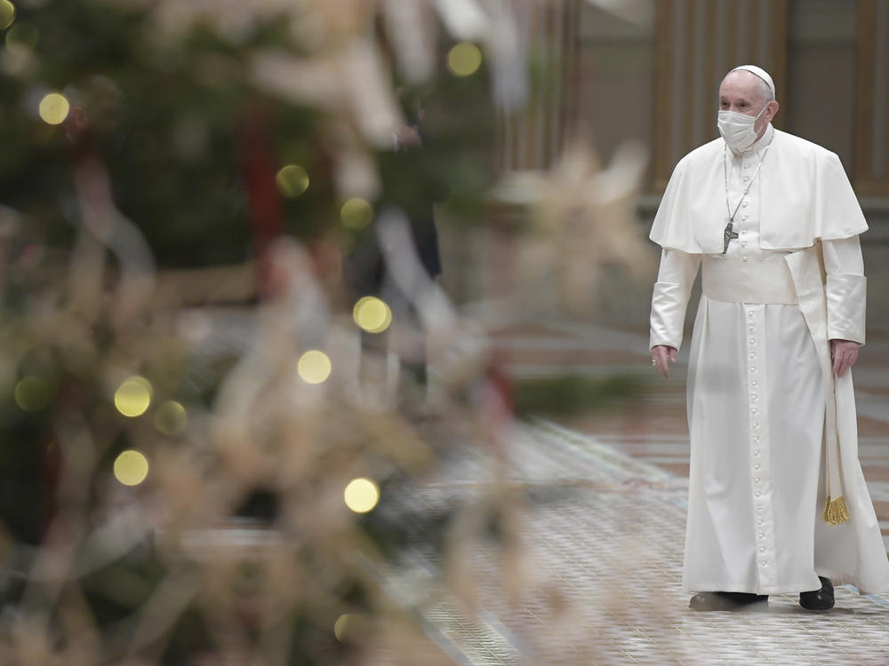 Pope Francis arrives to deliver his Christmas Day message, Urbi et Orbi, in the Apostolic Palace in Vatican City.