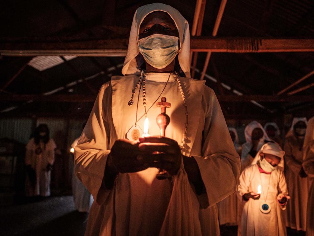 Worshippers of Legio Maria wearing face masks as a preventive measure against the spread of COVID-19 attend the Christmas service at their church in the Kibera slum of Nairobi, Kenya, on Dec. 25, 2020.