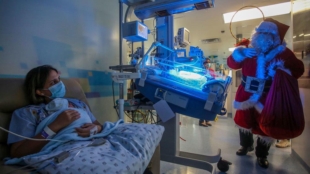 A health worker dressed as Santa Claus visits patients in a hospital in Cali, Colombia, on Dec. 24, 2020.