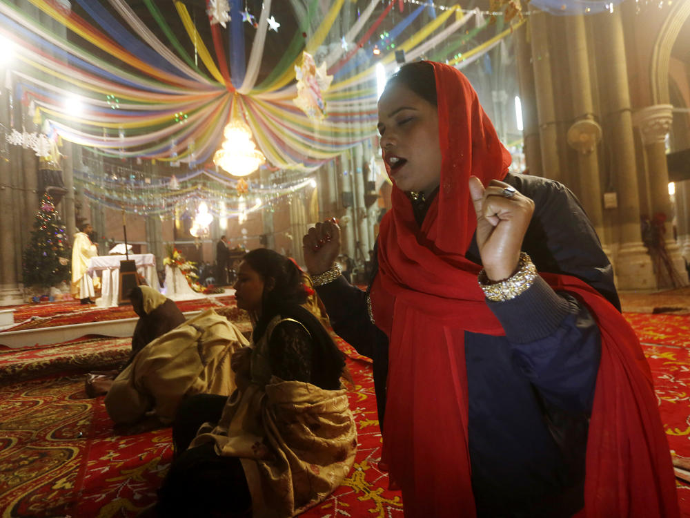 Christian women pray during a Christmas mass in Sacred Heart Cathedral in Lahore, Pakistan, Friday, Dec. 25, 2020.