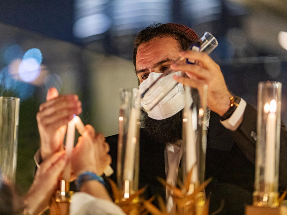 Rabbi Levi Duchman lights a menorah during Hanukkah at a private residence in Dubai, United Arab Emirates, in December.