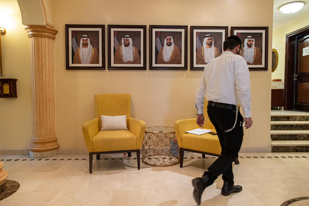 A Jewish man walks past portraits of UAE royalty in the Jewish Community Center in Dubai in December.