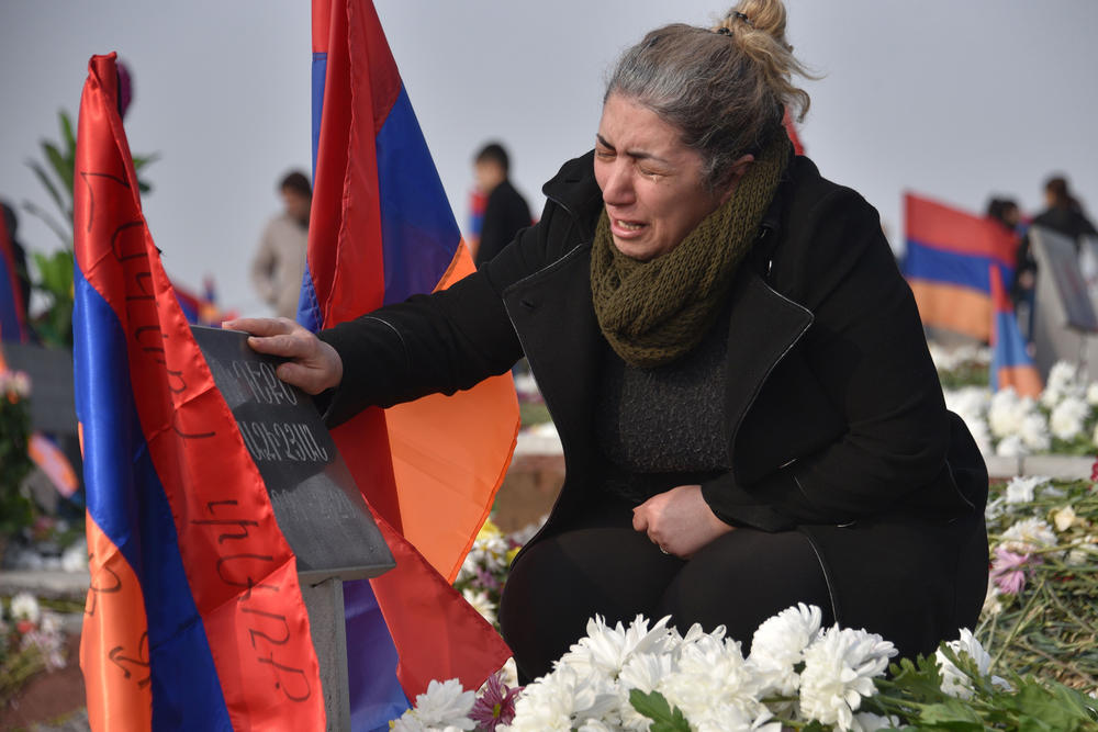 Mourners in Yerevan, Armenia, visit the graves of relatives killed during the Nagorno-Karabakh conflict between Azerbaijan and Armenia, Dec. 12. Fierce fighting erupted in the fall, a continuation of a war that started 30 years ago. A Russian-backed cease-fire went into effect in November.