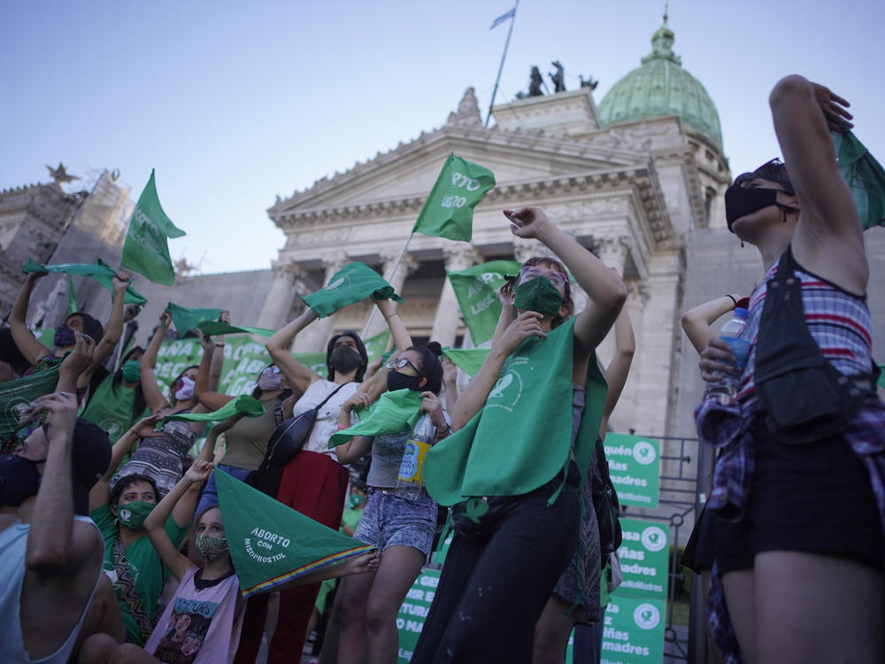 Abortion-rights activists in favor of a bill legalizing abortion gather outside the legislative building in Buenos Aires, Argentina, on Thursday.