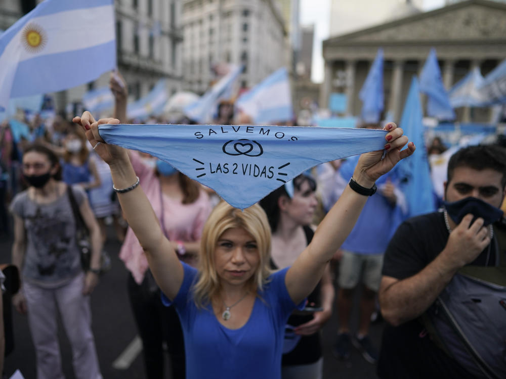 An anti-abortion rights activist holds a handkerchief with text in Spanish that reads, 