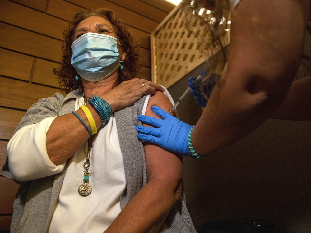 Edna Halup, a staff member at a private nursing home, receives a Pfizer COVID-19 vaccine, in Ganei Tikva, Israel, on Dec. 22.