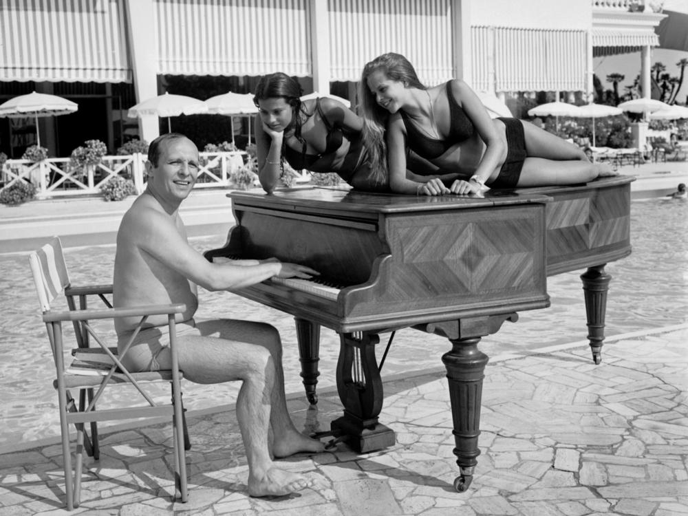 A shot of jazz pianist Claude Bolling and friends, taken on a beach in Cannes, France in 1969.