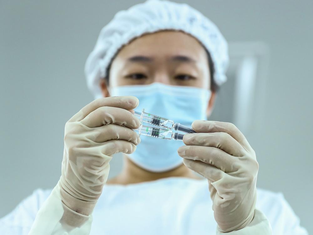 A staff member checks a COVID-19 vaccine package in Beijing. China has approved Sinopharm's vaccine after clinical trials showed it has a 79% efficacy against COVID-19.
