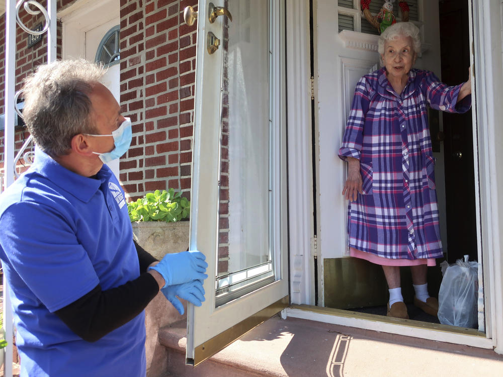 Homebound senior Louise Delija, 93, receives a meal delivery in Brooklyn, New York. Since the pandemic began, demand for help from seniors has ballooned.