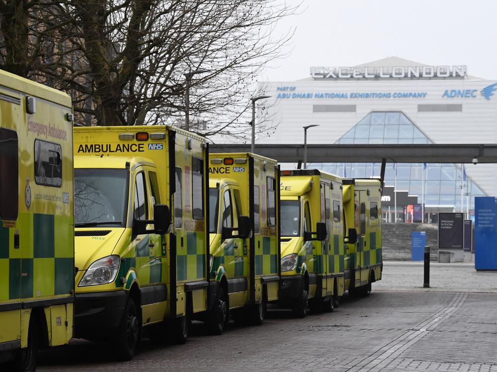 Ambulances are parked outside the NHS Nightingale hospital at the ExCeL center in east London on Friday. Hospitals in the U.K. are preparing for an influx of patients as the coronavirus continues to spread.