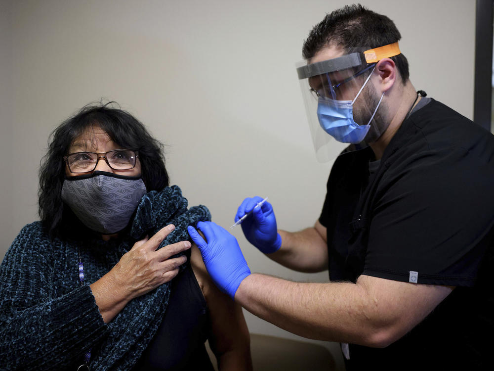 Meda Nix, a citizen of the Cherokee Nation and a Cherokee language speaker, receives a COVID-19 vaccine from Dr. Matthew Reece at the Cherokee Nation Outpatient Health Center Thursday, Dec. 17, 2020, in Tahlequah, Okla.