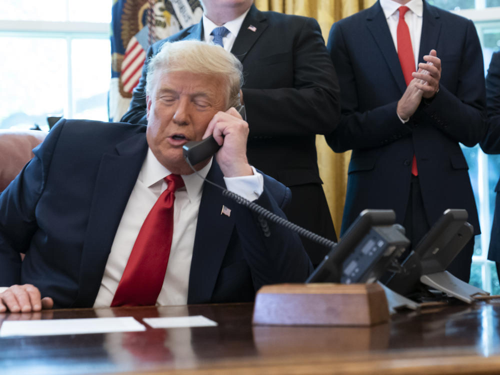 President Trump's phone call on Saturday with Georgia Secretary of State Brad Raffensperger spurred debates over whether the call broke the law. Here, Trump talks to the leaders of Israel and Sudan in October.