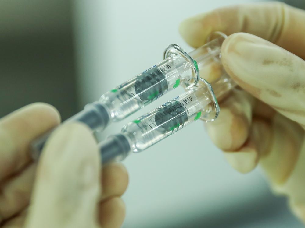 A staff member checks the packaging quality of COVID-19 inactivated vaccine products at a packaging plant of the Beijing Biological Products Institute Co. in Beijing last month.