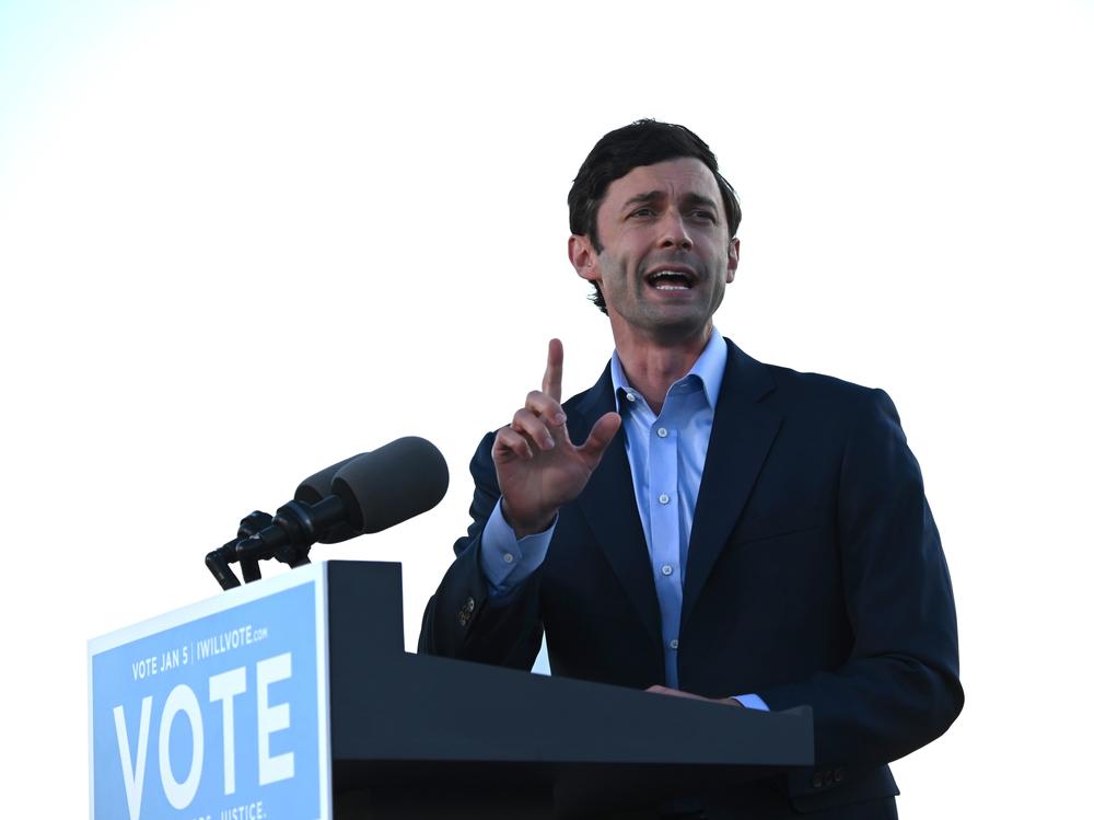 Democrat Jon Ossoff speaks at a rally outside of Center Parc Stadium in Atlanta on Monday.