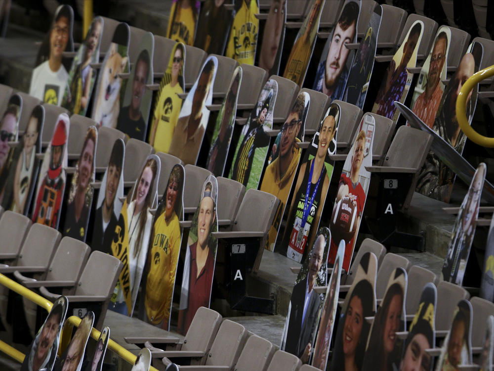 The NCAA says it hasn't decided on whether any fans will be allowed to watch the men's basketball tournament, which will center on Indianapolis. Here, cardboard placards populate Iowa's Carver-Hawkeye Arena last month.