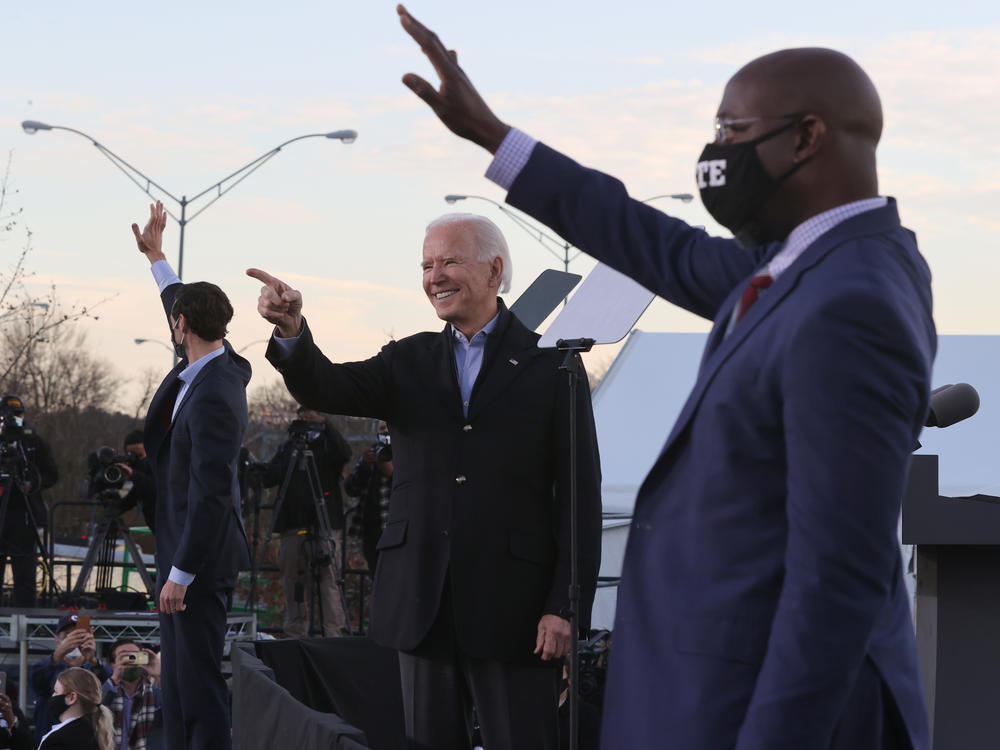 President-elect Joe Biden campaigns alongside Democratic Senate candidates Jon Ossoff (left) and the Rev. Raphael Warnock on Monday in Atlanta.