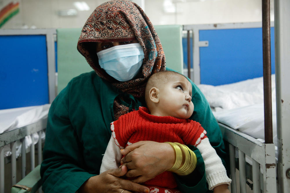 Zareena, 30, holds her fifth child, 1-year-old Fariba, at the ward for malnourished children at the Indira Gandhi Children's Hospital in Kabul.