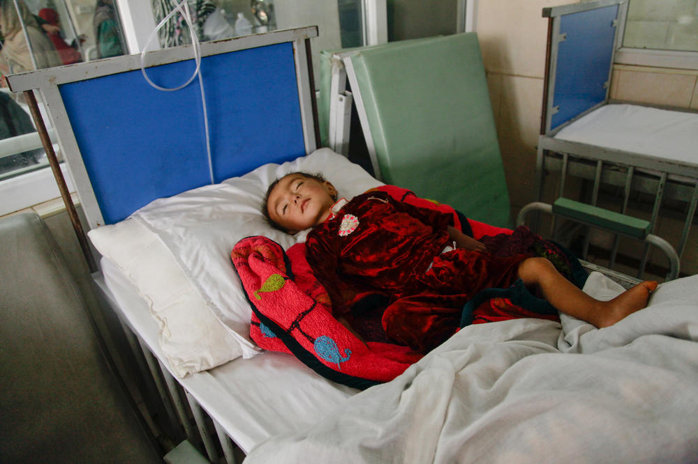 Parvana, 18 months old, lies on a gurney at a ward for malnourished children at the Indira Gandhi Children's Hospital in Kabul.
