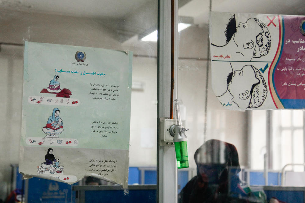 Two posters on the glass partition in a ward for malnourished children at the Indira Gandhi Children's Hospital in Kabul show the correct way to breastfeed a child. Proper, frequent breastfeeding is key to avert malnutrition among babies, but health workers say many Afghan women don't know that.
