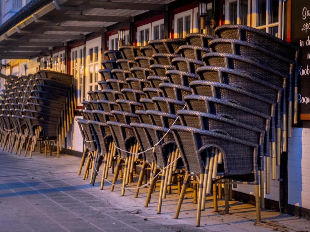 Chairs are piled up outside a restaurant Monday in the Baltic Sea resort town of Haffkrug, Germany.