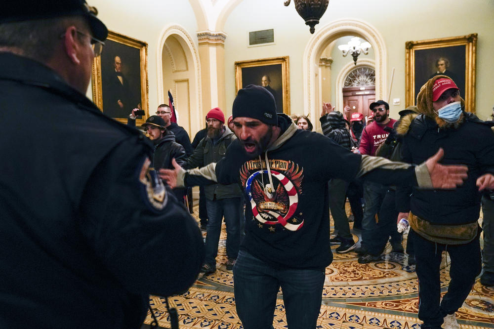 Protesters gesture to U.S. Capitol Police in the hallway outside of the Senate chamber on Wednesday.